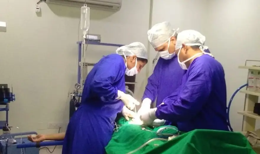 Doctors performing cesarean section
